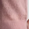 Jerséis con cuello polo y logotipo de pedrería Jerséis con cuello polo y logotipo de pedrería