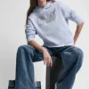 Sudadera con capucha y logotipo de pedrería superpuesto